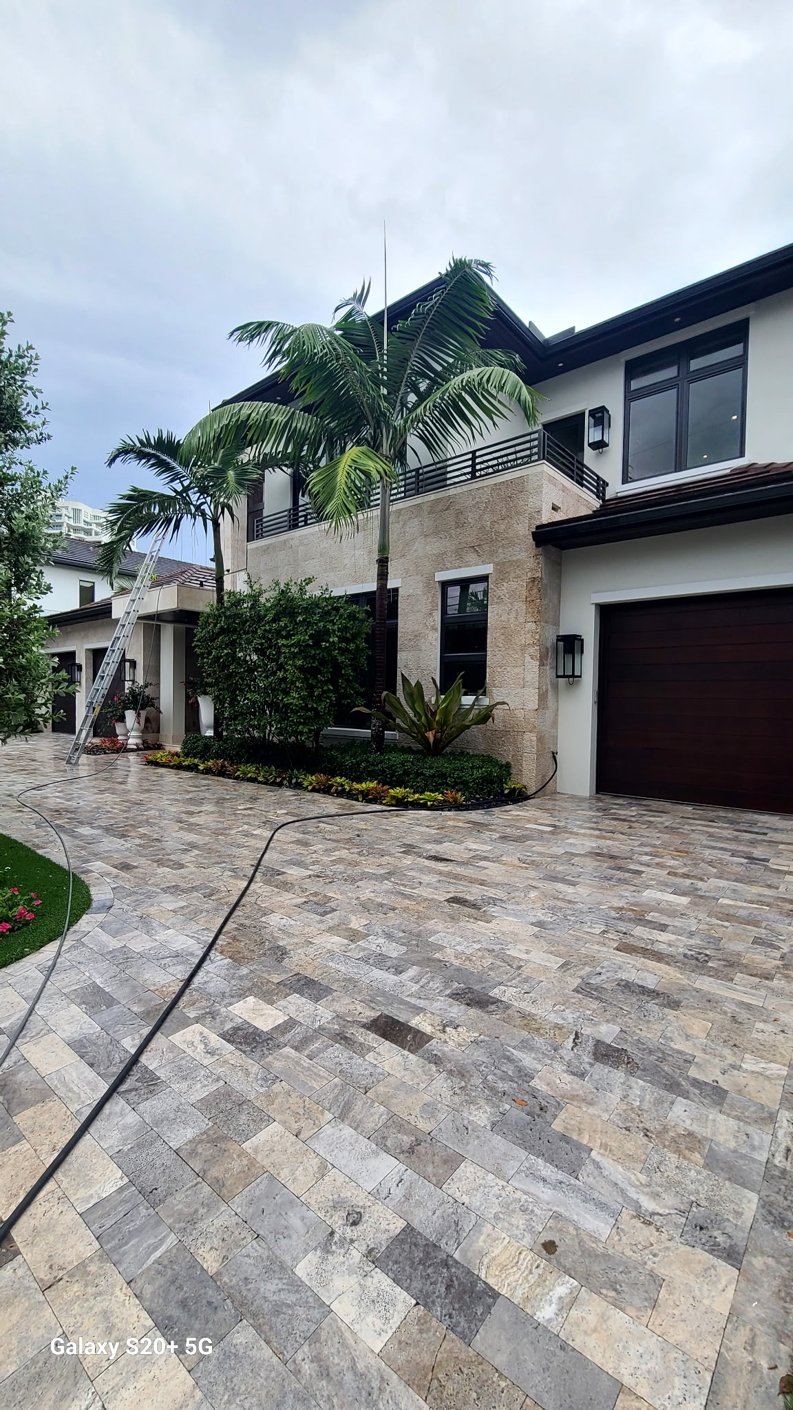 Large travertine paver driveway cleaned by JB Powerwash
