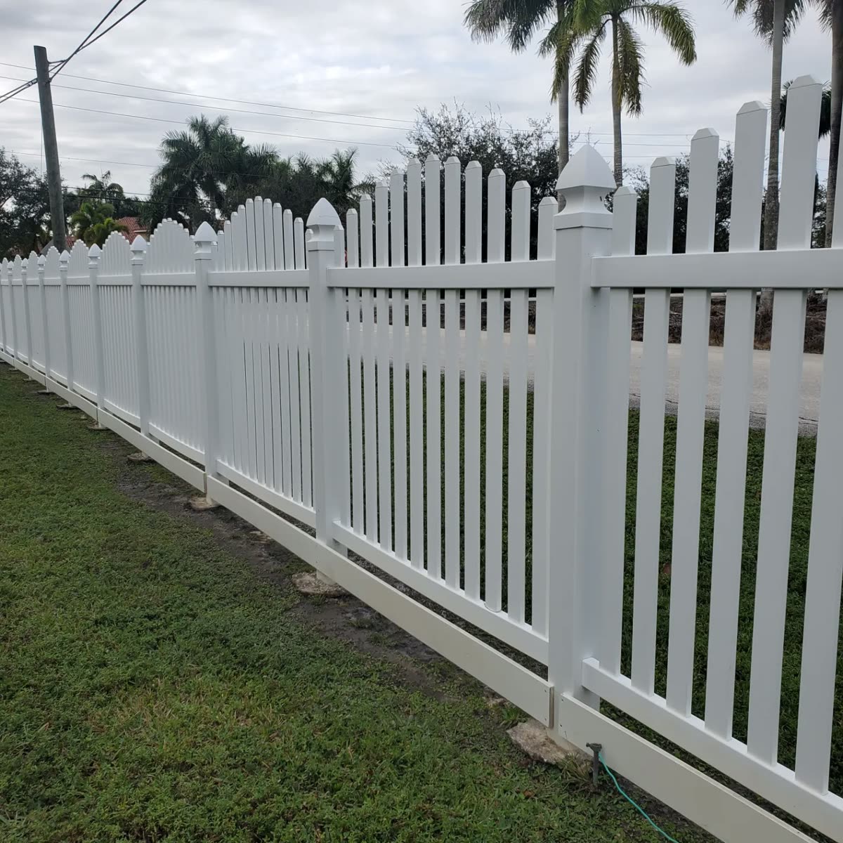 White picket fence after a JB Powerwash soft wash — algae gone, back to bright white